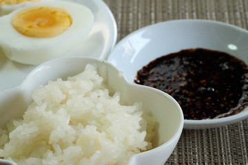 Sticky rice or glutinous rice and boiled eggs served in restaurant, high vitamin, mineral such as selenium, copper and phosphorous food useful for human growth, tradition Thai food and export product