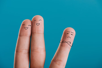 cropped view of fingers as happy couple and third wheel isolated on blue