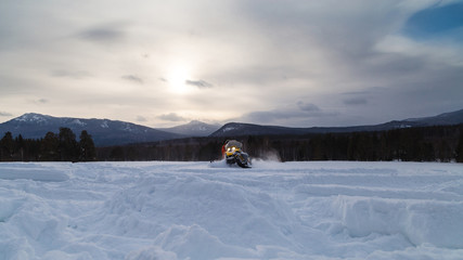 Athlete on a snowmobile.