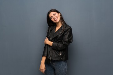 Teenager girl over grey wall smiling