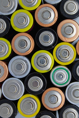 Top view of used alkaline batteries.  Closeup of old AA batteries ready for recycling, colorful...