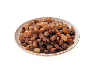 Raisins in bowl isolated on white background