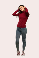 A full-length shot of a Teenager girl with turtleneck smiling over isolated background