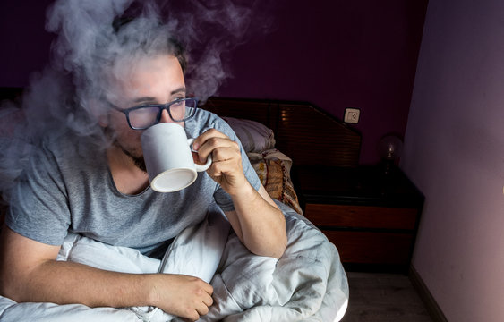 drinking coffee in bed, guy man with glasses with boiling cup