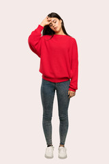 A full-length shot of a Teenager girl with red sweater with tired and sick expression over isolated background