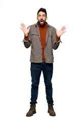 Full-length shot of Handsome man with beard with surprise and shocked facial expression on isolated white background