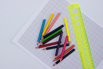 Color Pencile and Rular On a plotting paper isolated with light background