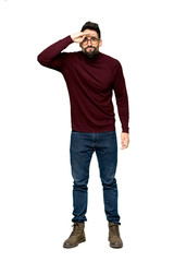 Fototapeta premium Full-length shot of Handsome man with glasses looking far away with hand to look something on isolated white background