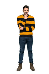 Full-length shot of Handsome man with striped sweater smiling and looking to the front with confident face on isolated white background
