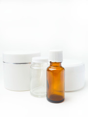 close up of beauty hygiene container on white background with essential oil glass bottles