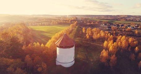 Autumn village landscape in aerial view. Sunny fall, natural sunflare. Nature, romantic scenic view in Poland.