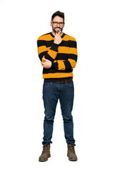 Full-length shot of Handsome man with striped sweater with glasses and smiling on isolated white background