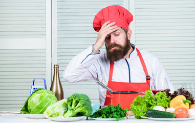 Fototapeta premium tired bearded man. chef recipe. Dieting organic food. Vegetarian salad with fresh vegetables. Cuisine culinary. Vitamin. Healthy food cooking. Mature hipster with beard. Last details