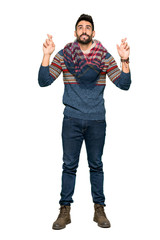 Full-length shot of Hippie man with fingers crossing and wishing the best on isolated white background