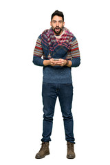 Fototapeta premium Full-length shot of Hippie man surprised and sending a message on isolated white background