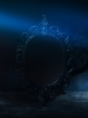 Mirror magic, fortune telling and fulfillment of desires. Fantasy with a mirror, dark room, magical...