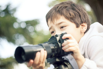 little boy with a camera taking a picture film camera vintage look photo teach class lesson course 