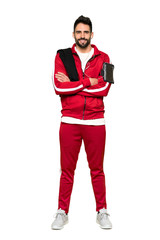 Fototapeta premium Full-length shot of Handsome sportman keeping the arms crossed in frontal position on isolated white background