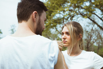 Happy young couple arm restling in the park