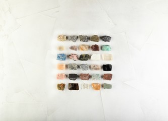 Set of minerals, a collection of rocks, minerals in the box on white cement background.