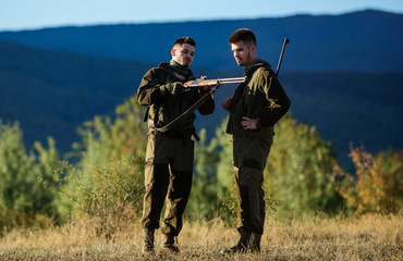 Man hunters with rifle gun. Boot camp. Hunting skills and weapon equipment. How turn hunting into hobby. Military uniform fashion. Friendship of men hunters. Army forces. Camouflage. Hunting period