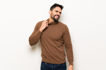 Fototapeta premium Handsome man over white wall with tired and sick expression