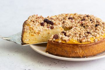 Cheesecake with pumpkin and crumble. No crust cheesecake. Healthy dessert. Light concrete background. Copy space.