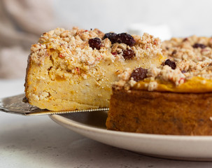 Cheesecake with pumpkin and crumble. No crust cheesecake. Healthy dessert. Light concrete background. Copy space.