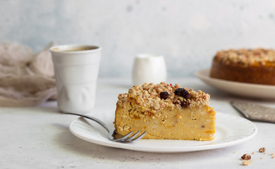 Cheesecake with pumpkin and crumble. No crust cheesecake. Healthy dessert. Light concrete background. Copy space.