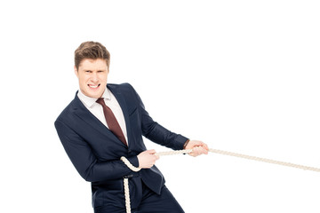 handsome young businessman in formal wear pulling rope isolated on white