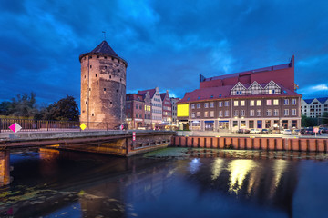 Fototapeta na wymiar Historic Brama Stagiewna (Milk cans gate) in old town at night in Gdansk, Poland