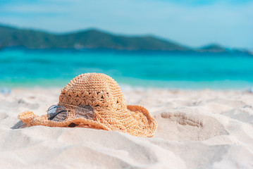 Straw hat on sand at the beach, Phuket in Thailand