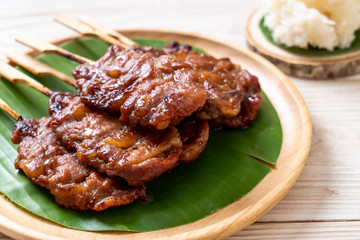 grilled skewered milk pork with white sticky rice