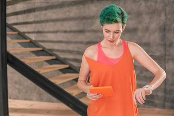 Woman checking time on smart watch running late for work