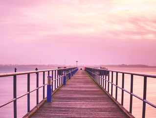 Fototapeta na wymiar Empty dock, calm sea and sky background.