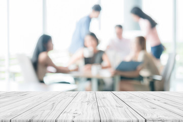 Empty wooden table with people meeting blur background ,can be used for montage or display products...