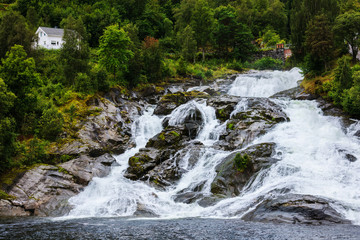 Fototapeta premium Hellesylt Fossen waterfall in the area Geirangerfjord