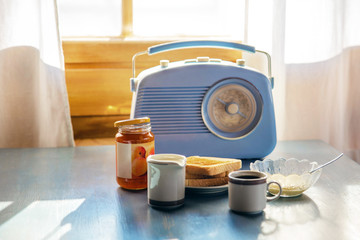 radio on the table, bread, milk in a glass