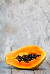 half of a papaya on marble background