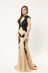 Full length photo of fashion model woman wearing elegant evening dress gown posing isolated on...