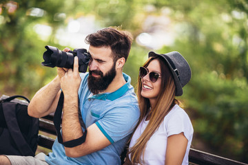 Happy tourist couple  in the park on a sunny day