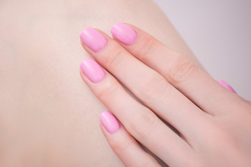 Obraz na płótnie Canvas Female hand with pink manicure. Close-up. Manicure salon