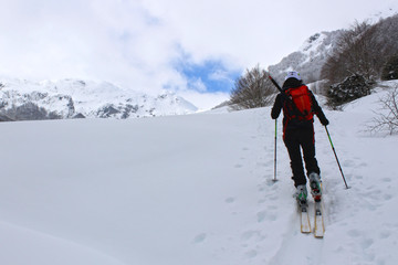 Fototapeta na wymiar girl doing touring ski in a mountain covered of snow