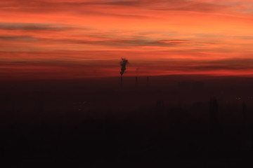 Obraz na płótnie Canvas Factory smoke at sunset sky