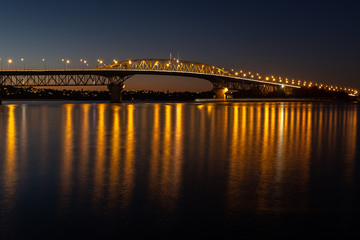 The Auckland harbour bridge lit up at night