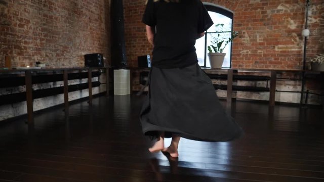 Barefoot mother and father legs walk and dance on a parquete floor spinning baby child daughter