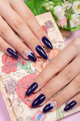 Obraz na płótnie Canvas Manicure and Hands Spa. Beautiful Woman Hands with blue nail Polish 