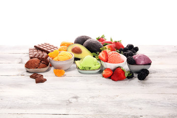 Set of ice cream scoops of different colors and flavours with berries, chocolate and fruits.