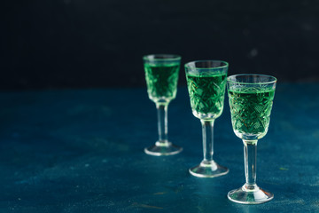 Traditional italian or czech liqueur or bitter with fennel. Three absinthe glass