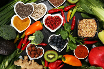 Healthy food clean eating selection. fruit, vegetable, seeds, superfood, cereals, leaf vegetable on rustic background